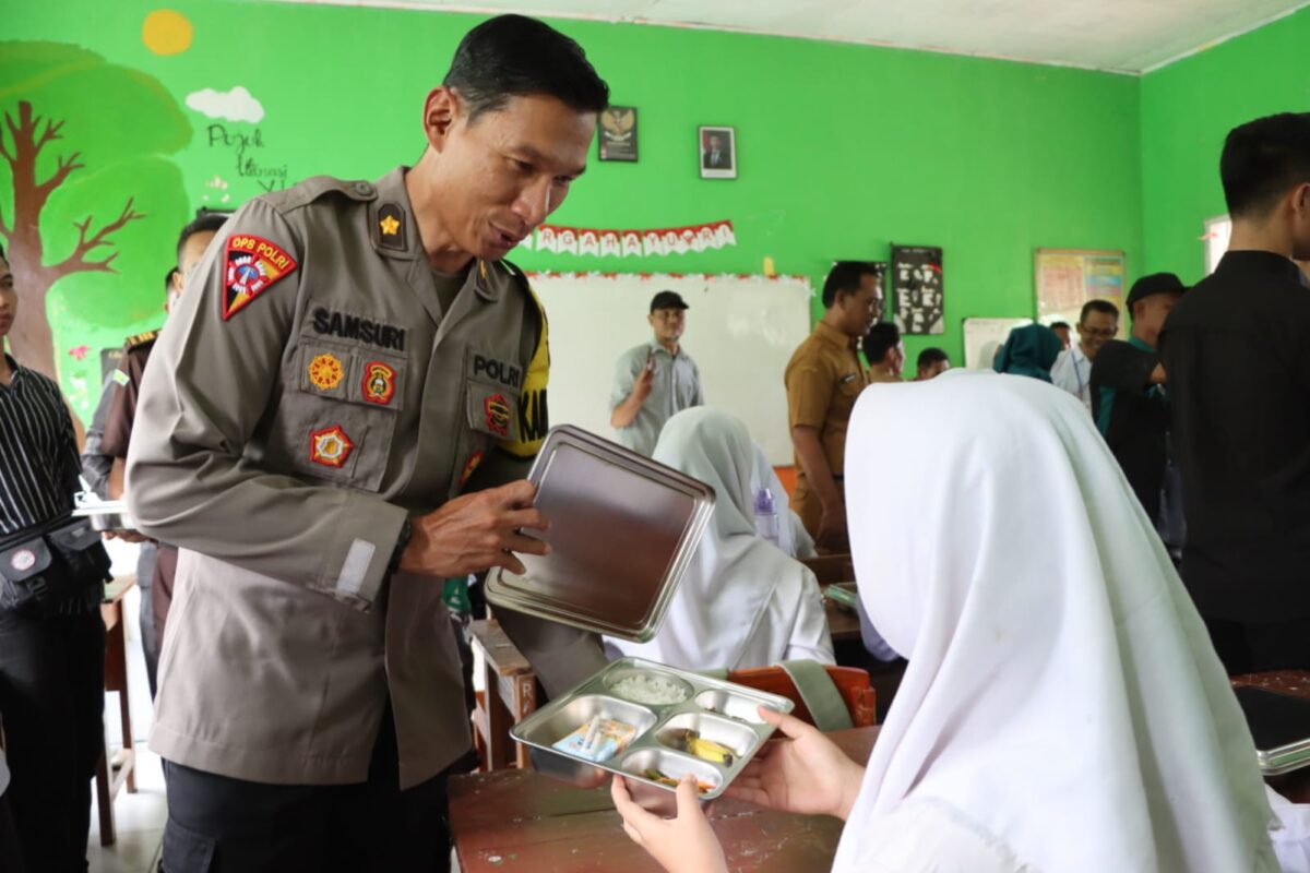 Kabag Ops Polres Tanggamus Kompol Samsuri saat menyerahkan MBG di SMAN 2 Kota Agung, Senin 14 April 2025 | Dok. Humas Polres Tanggamus.