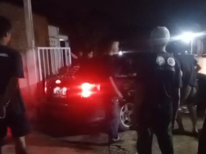 Warga berkumpul di depan rumah di Kelurahan Pajaresuk, Pringsewu, saat penggerebekan diduga kasus perselingkuhan yang melibatkan pejabat BKPSDM Lampung Tengah dan seorang guru SD, Selasa malam (13/5/2025). (Davit/Prioritastv.com)