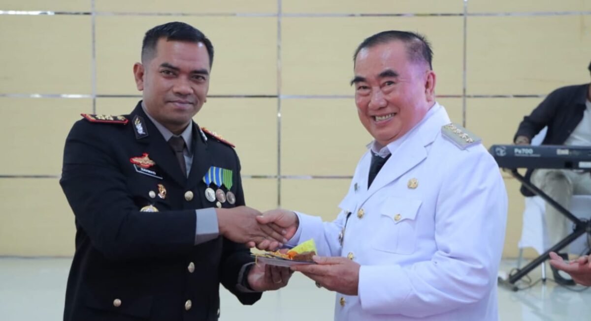 Bupati Tanggamus Moh. Saleh Asnawi saat menyerahkan tumpeng kepada Kapolres AKBP Rahmad Sujatmik, Selasa 1 Juli 2025 | Herdi/Media Prioritastv.com.