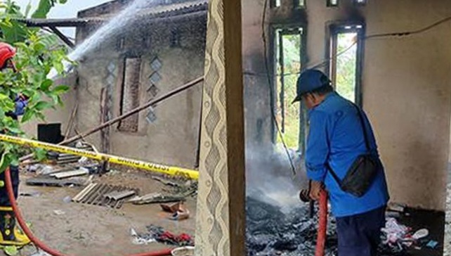 Petugas Damkar saat melakukan pendinginan pembakaran rumah Salam, terduga pelaku pembunuhan di Natar, Lampung Selatan, Kamis 31 Juli.2025 |