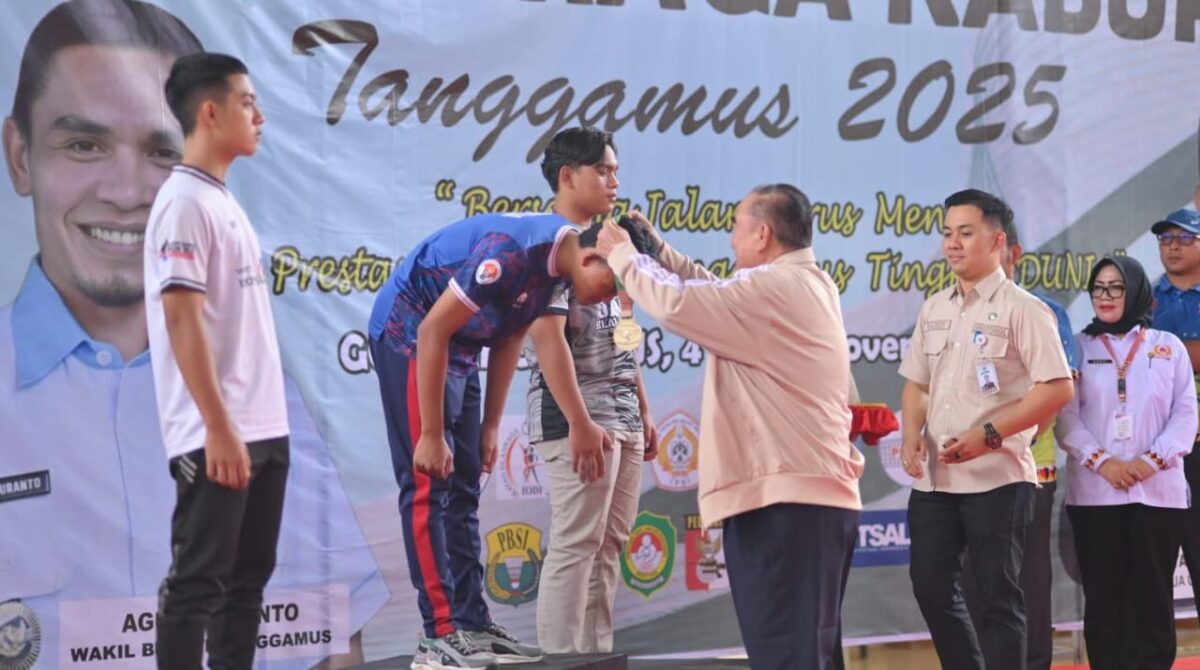 Bupati Tanggamus H. Moh. Saleh Asnawi saat mengalungkan medali kepada juara salah satu Cabor Porkab 2025 di GOR Tanggamus, Senin 24 November 2025 | Herdi/Media Prioritastv.com.