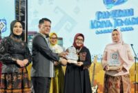 Asisten Pemerintahan dan Kesra Setda Provinsi Lampung, M. Firsada, mewakili Gubernur Lampung Rahmat Mirzani Djausal saat menyerahkan penghargaan kepada Ketua Dekranasda Tanggamus, Hj. Siti Mahmudah Saleh Asnawi di Gedung Graha Wangsa Sabtu (22/11/2025), malam | ist/Media Prioritastv.com.