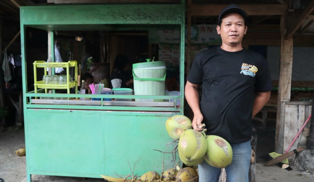 Joko, pemilik lapak es kelapa muda di Jalan Bhayangkara depan kantor Pos Kota Agung saat menunjukan jualannya, Senin, 16 Februari 2026 | Sumentri/Media Prioritastv.com.