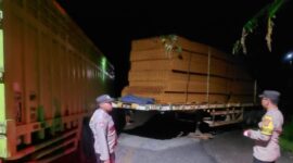 Anggota Polsek Semaka saat melakukan pemeriksaan dan pengamanan TKP senggolan dua truk fuso di tanjakan Kaliwusong, Sedayu, Semaka, Jumat 6 Maret 2026, malam | Dok. Humas Polres Tanggamus.