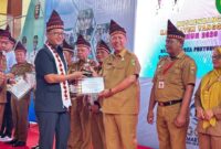 Kadisdukcapil Tanggamus, Maradona saat menerima penyerahan Tanggamus Award 2026 dalam Musrenbang di GOR Kota Agung, Selasa 31 Maret 2026 |