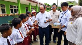 Azis Gagap didampingi Ketua Rel MBG Pusat Roy Marzuk dan ketua Yayasan Alam Abadi Tanggamus Firlinda saat membagikan susu kepada pelajar SD Negeri 3 Gisting Atas Kecamatan Gisting Tanggamus, Senin 25 Mei 2026 | Herdi/Media Prioritastv.com.