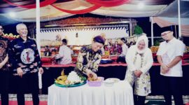 Bupati Pringsewu Riyanto Pamungkas saat memotong tumpeng rantkaian bersih desa di Kelurahan Fajaresuk, Sabtu 20 Juni 2026, malam | Samuel/Media Prioritastv.com.