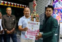 Razes saat menerima piala dan uang tunai atas raihan juara kontes Dangdut Karang Taruna di Taman Soekarno Kota Agung Tanggamus, Sabtu 29 Agustus 2026, malam | Herdi/Media Prioritastv.com.
